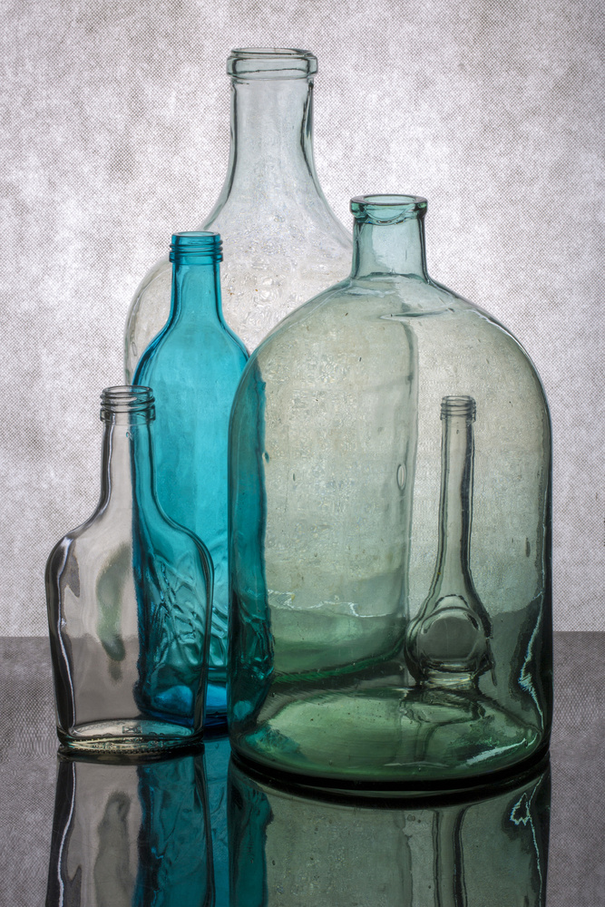 Still life with different transparent glass bottles from Brig Barkow